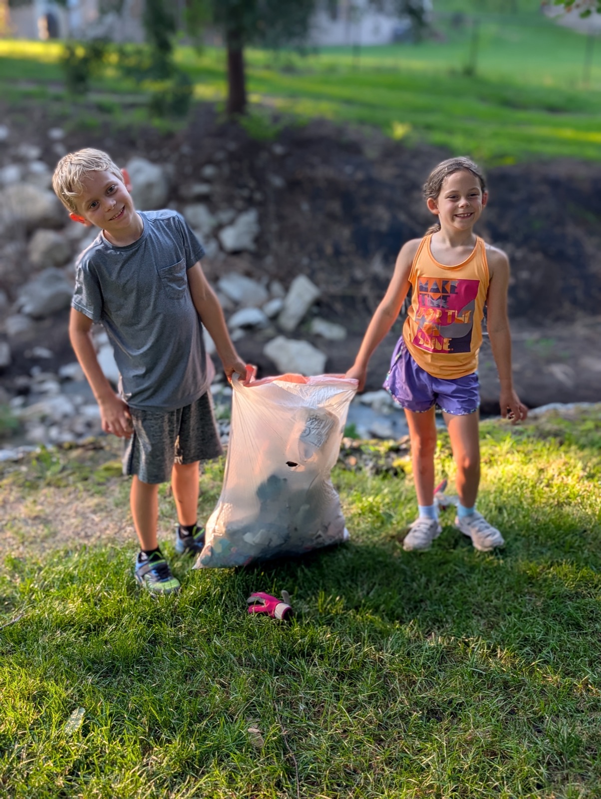 Malachi and Nicolette with the full trash bag