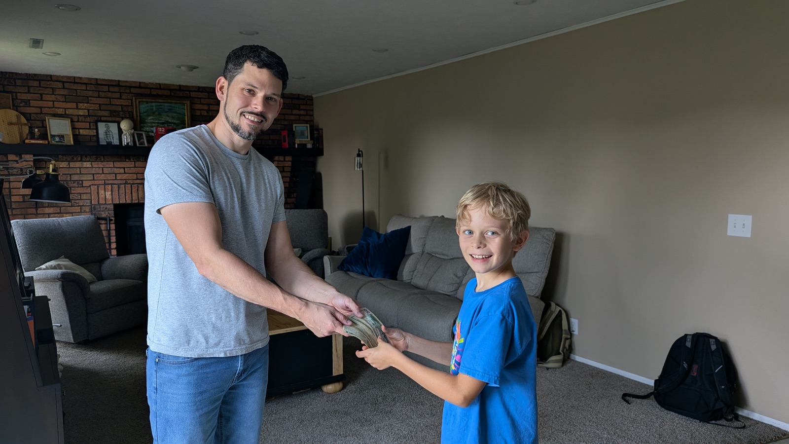 Malachi handing his earned cash to his dad