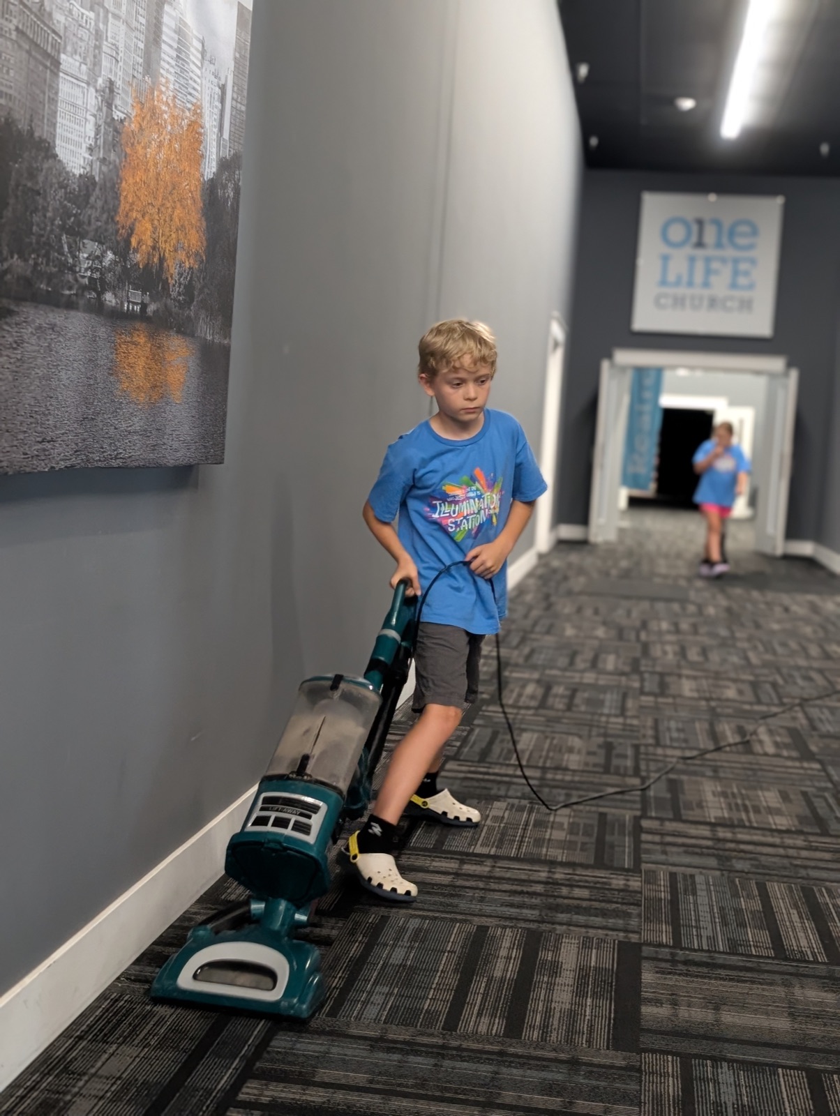 Malachi vacuuming the church